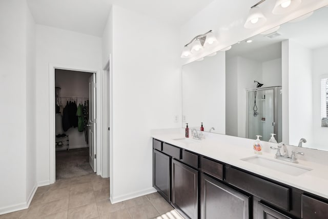 bathroom featuring tile patterned flooring, vanity, and an enclosed shower