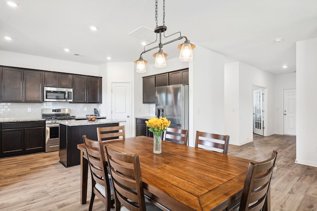 dining room with light hardwood / wood-style flooring