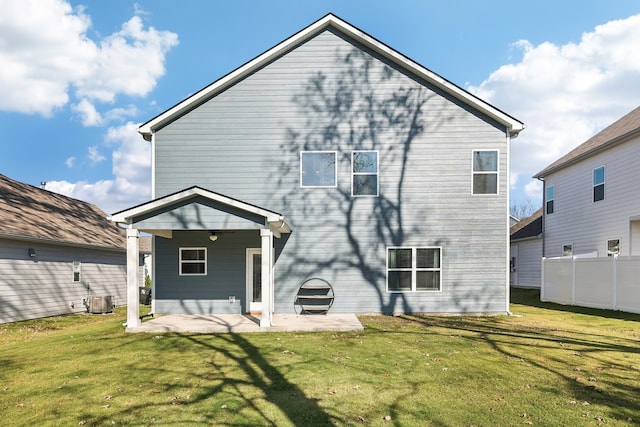 rear view of property with central air condition unit, a patio area, and a lawn