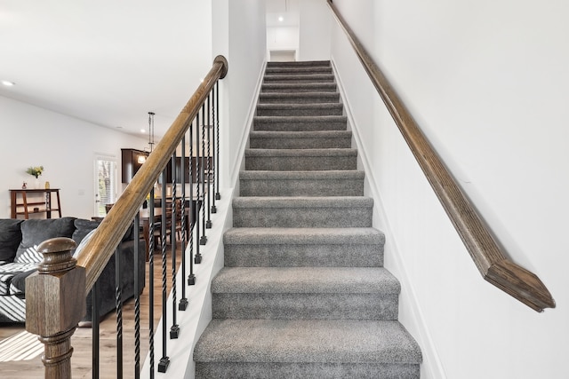 stairway featuring hardwood / wood-style floors