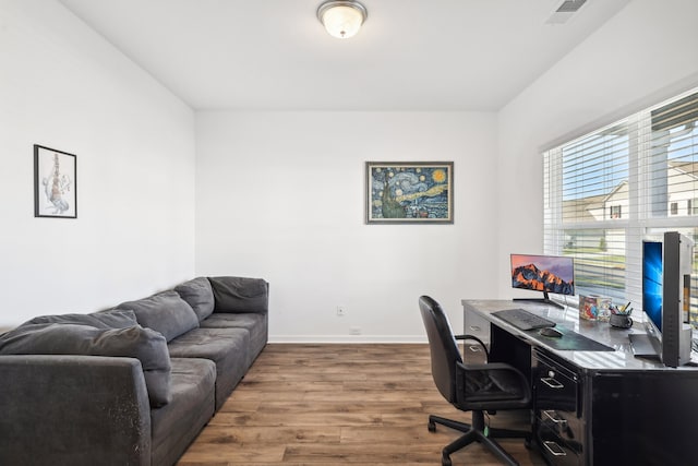 office space with wood-type flooring