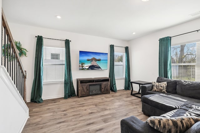 living room with plenty of natural light and light hardwood / wood-style flooring