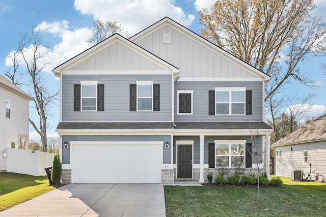 craftsman-style home with cooling unit, a front yard, and a garage