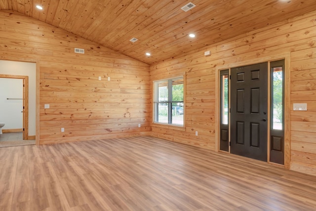 foyer featuring vaulted ceiling, wood ceiling, wooden walls, and light hardwood / wood-style flooring