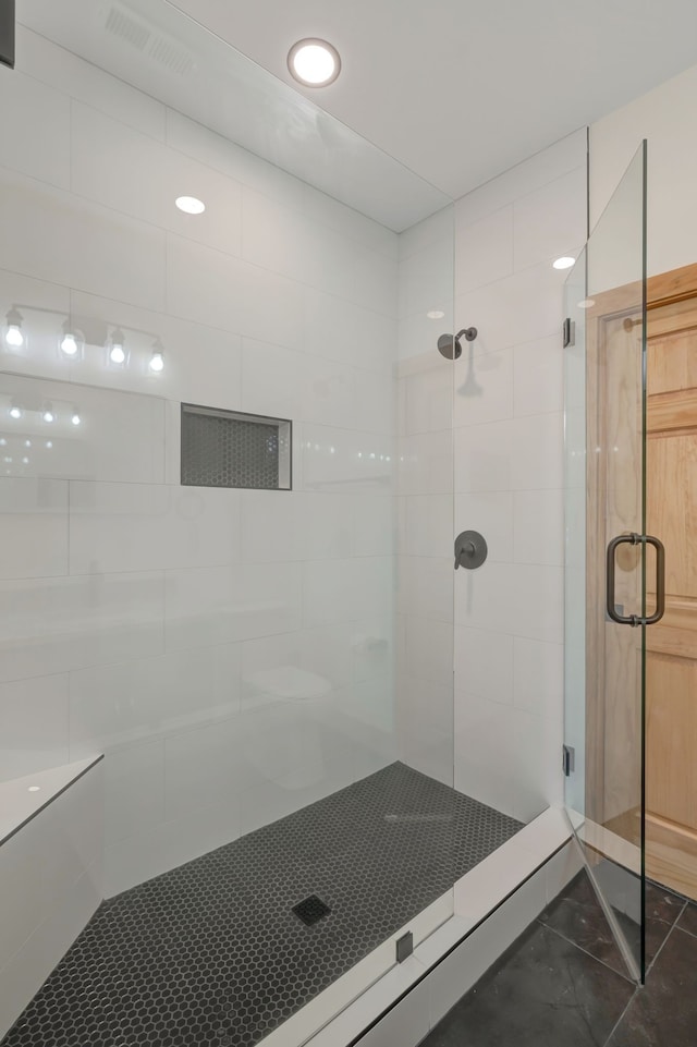 bathroom with a shower with door