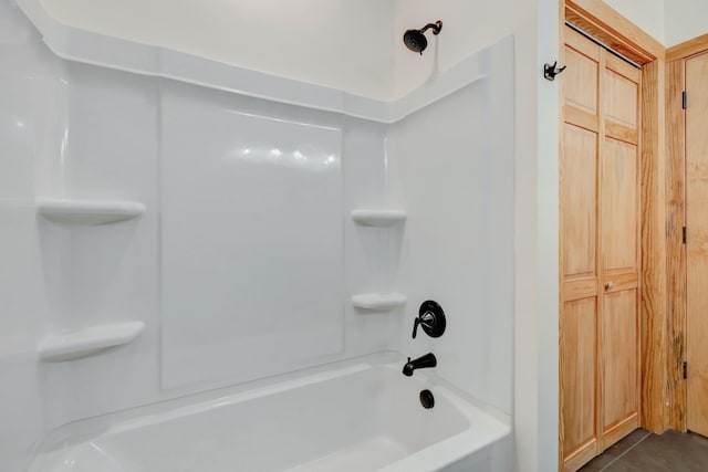 bathroom with tile patterned flooring and shower / bath combination