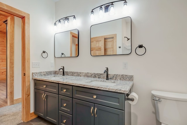 bathroom featuring tile patterned floors, vanity, and toilet