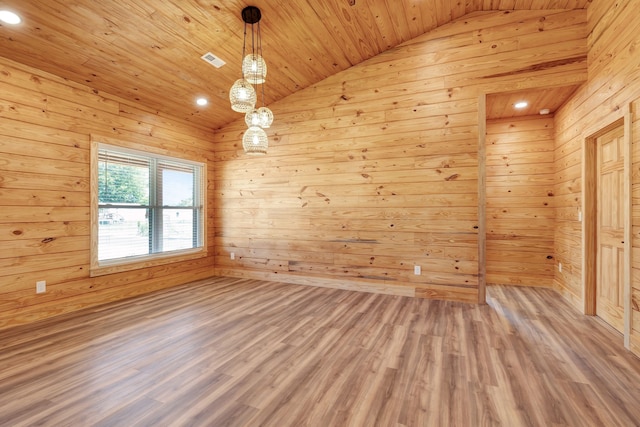 unfurnished room with wooden walls, hardwood / wood-style floors, wood ceiling, and vaulted ceiling