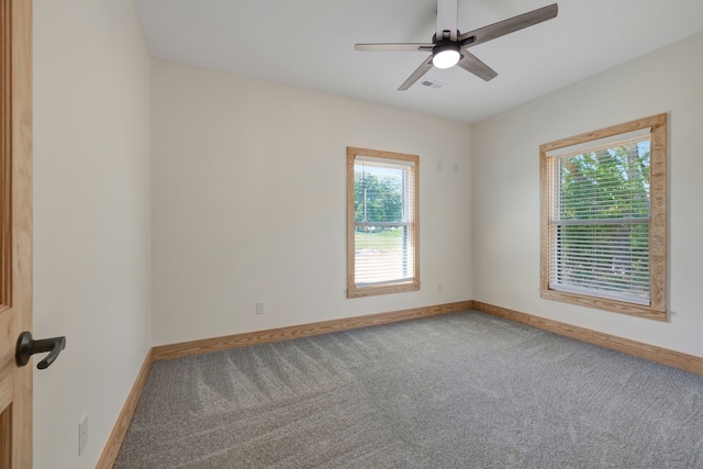 spare room with carpet flooring, ceiling fan, and plenty of natural light