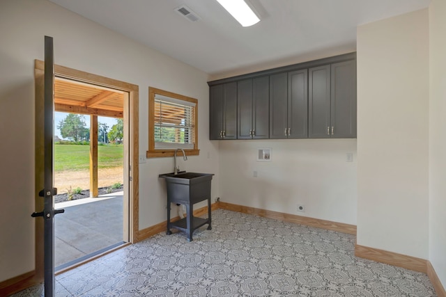 laundry room featuring washer hookup, electric dryer hookup, and cabinets