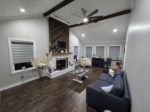 living room featuring ornamental molding, ceiling fan, hardwood / wood-style flooring, beamed ceiling, and a fireplace