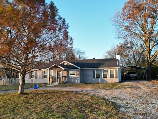 single story home featuring a front yard and a carport