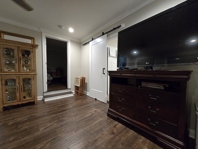 interior space featuring ornamental molding, a barn door, and dark wood-type flooring