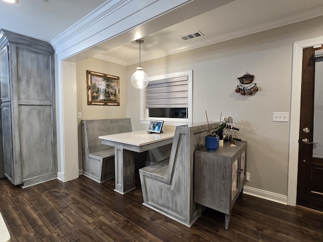 dining area featuring dark hardwood / wood-style floors and crown molding