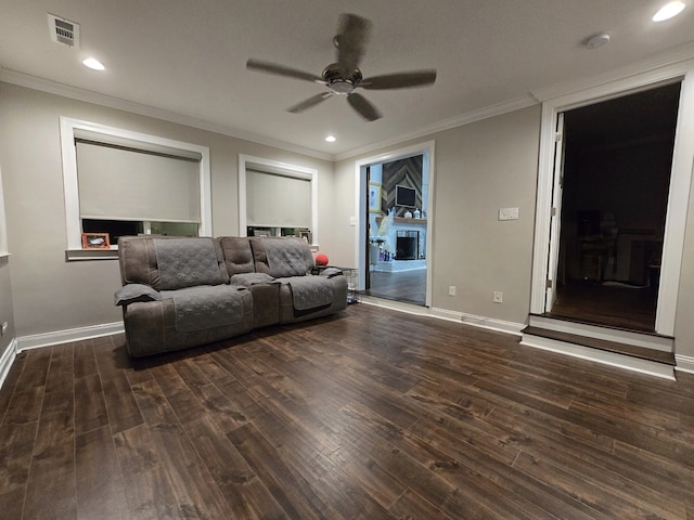 living room with ceiling fan, dark hardwood / wood-style flooring, and ornamental molding