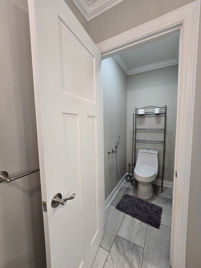 bathroom with crown molding and toilet