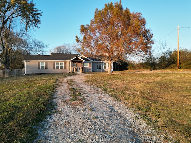 ranch-style house with covered porch and a front yard