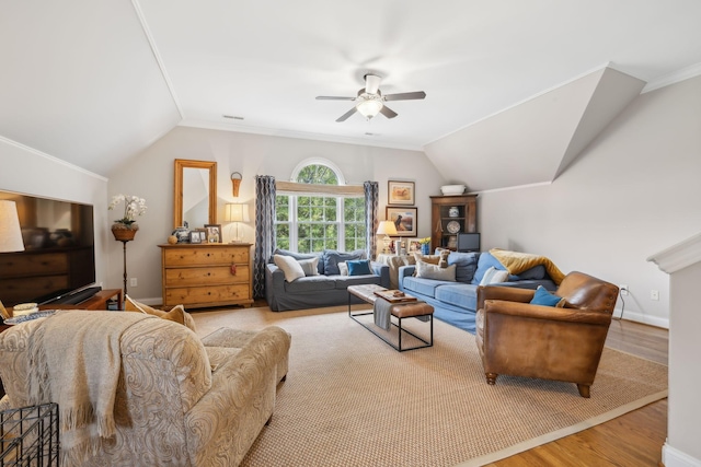 living room featuring ceiling fan, vaulted ceiling, crown molding, and light wood-type flooring