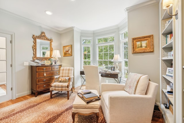 living area featuring hardwood / wood-style flooring and ornamental molding