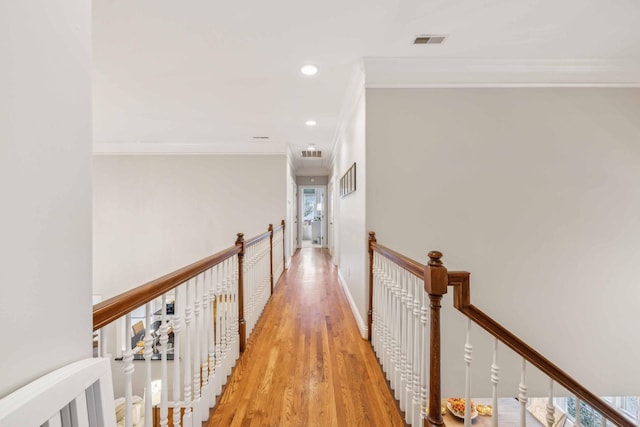 hallway with crown molding and light wood-type flooring