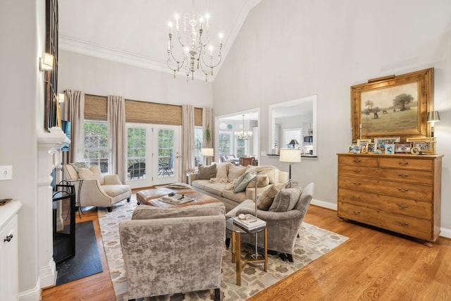 living room featuring high vaulted ceiling, a fireplace, crown molding, and light hardwood / wood-style flooring