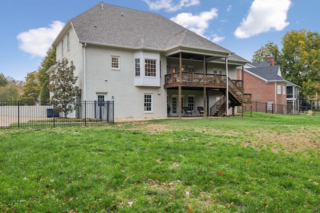 back of house with a deck and a lawn