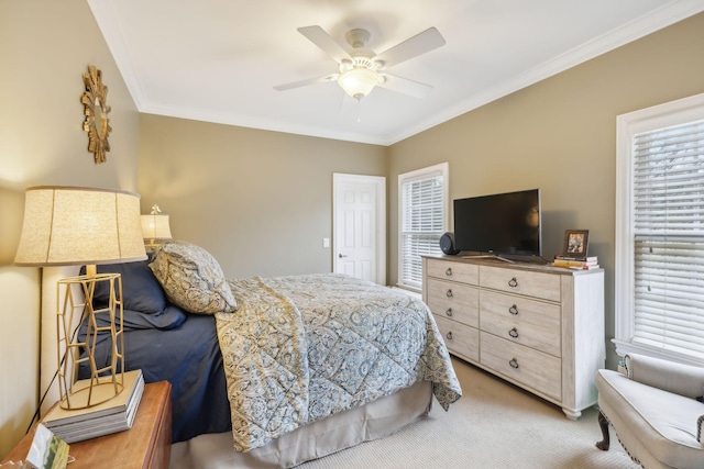 bedroom with ceiling fan, ornamental molding, and carpet floors