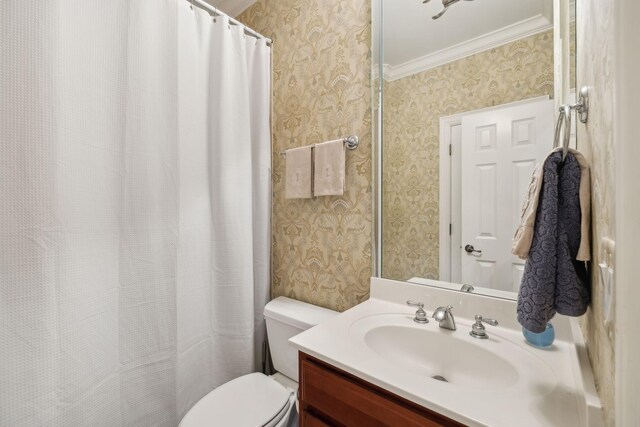 bathroom featuring toilet, vanity, and crown molding