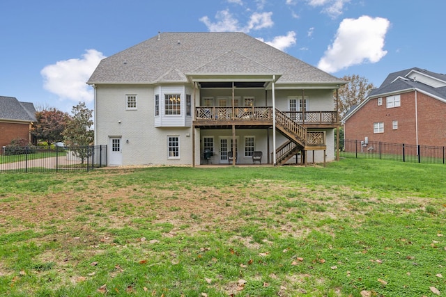 back of house featuring a wooden deck and a lawn