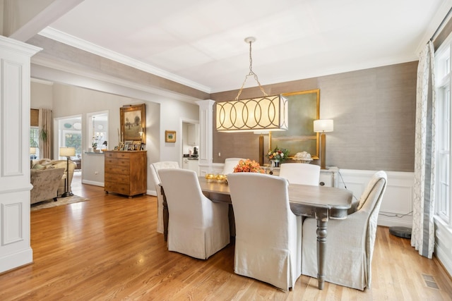 dining room featuring ornamental molding and light hardwood / wood-style floors