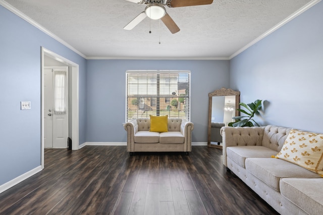 living room featuring ceiling fan, dark wood-type flooring, a textured ceiling, and ornamental molding