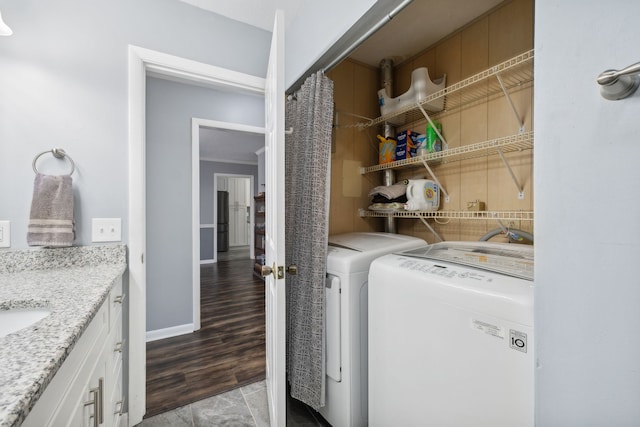 laundry room featuring washer and clothes dryer and light wood-type flooring