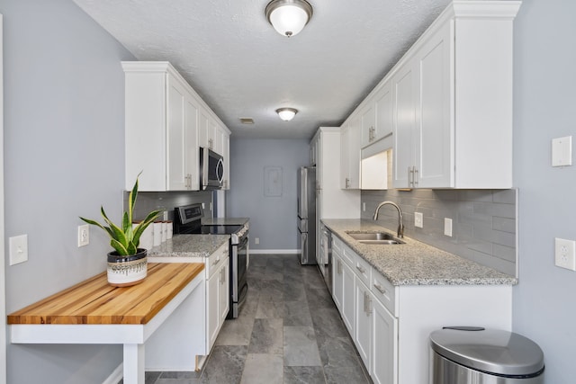 kitchen featuring white cabinets, sink, and stainless steel appliances