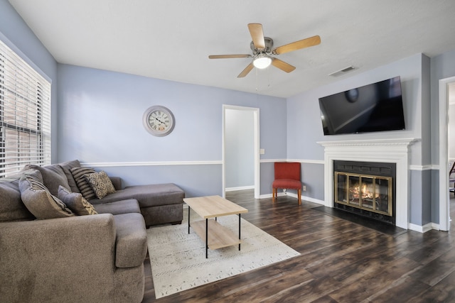 living room featuring ceiling fan and dark hardwood / wood-style flooring