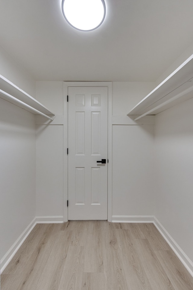 spacious closet featuring light hardwood / wood-style flooring