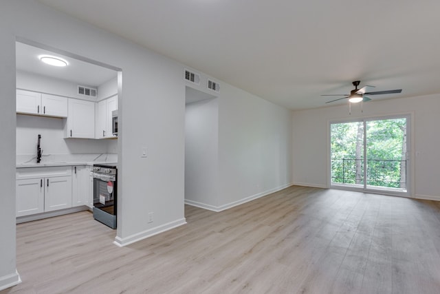 kitchen featuring light hardwood / wood-style floors, sink, white cabinetry, and stainless steel appliances