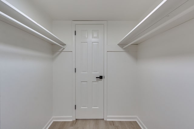 spacious closet with light hardwood / wood-style floors