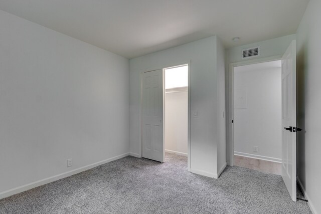 unfurnished bedroom with light colored carpet