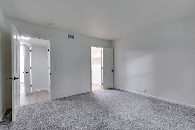 unfurnished bedroom with light colored carpet