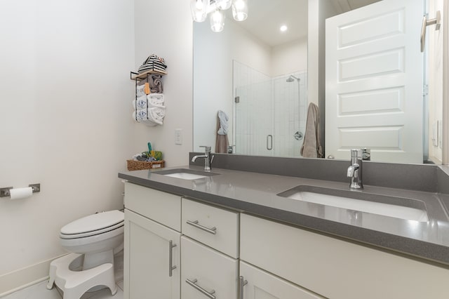 bathroom with a shower with door, vanity, and toilet