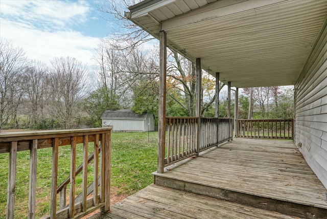 deck featuring an outbuilding and a yard