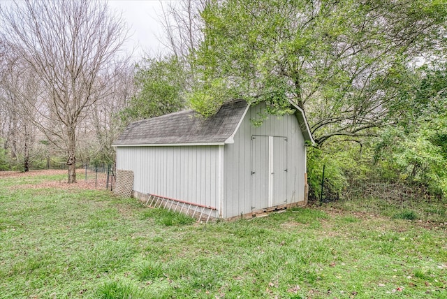 view of outbuilding with a lawn