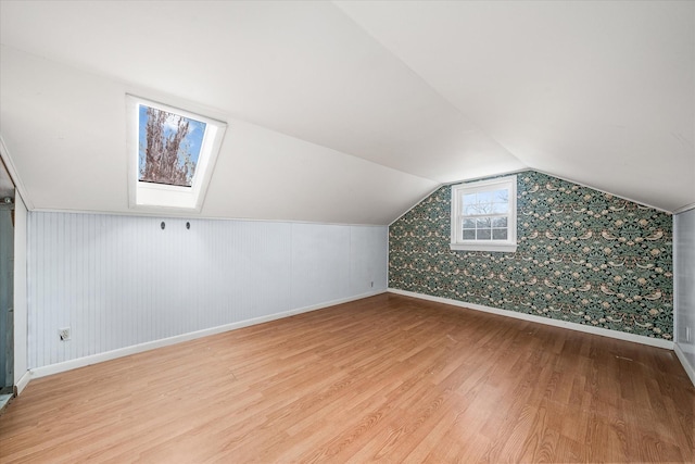 2269 Bowman Loop, Crossville, TN 38571 - additional living space with wood finished floors, baseboards, vaulted ceiling, a skylight, and wallpapered walls