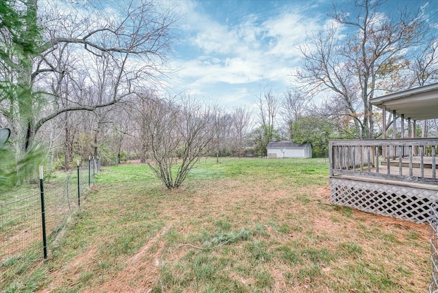 view of yard with a storage unit and a wooden deck