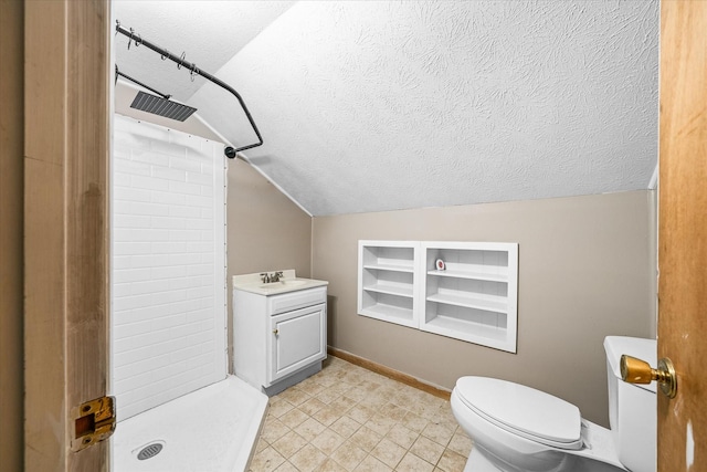 2269 Bowman Loop, Crossville, TN 38571 - bathroom with a tile shower, a textured ceiling, lofted ceiling, toilet, and baseboards