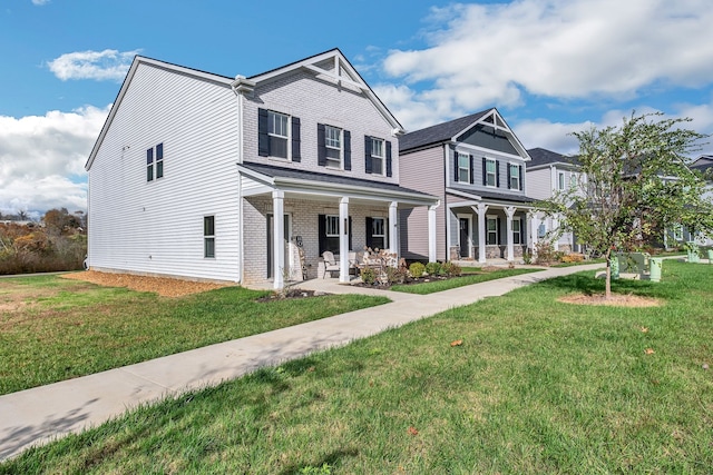 view of front of home featuring covered porch and a front lawn