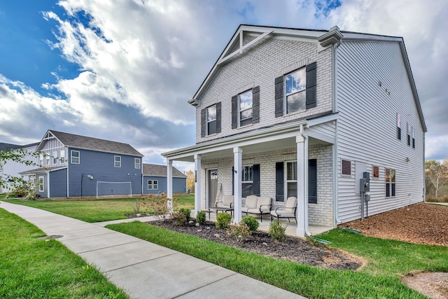 view of front of home featuring covered porch and a front yard