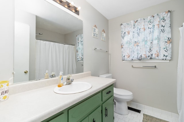 bathroom featuring tile patterned flooring, vanity, and toilet