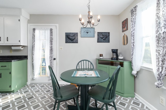 dining space with an inviting chandelier