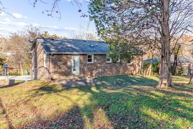 back of property featuring a patio area and a yard